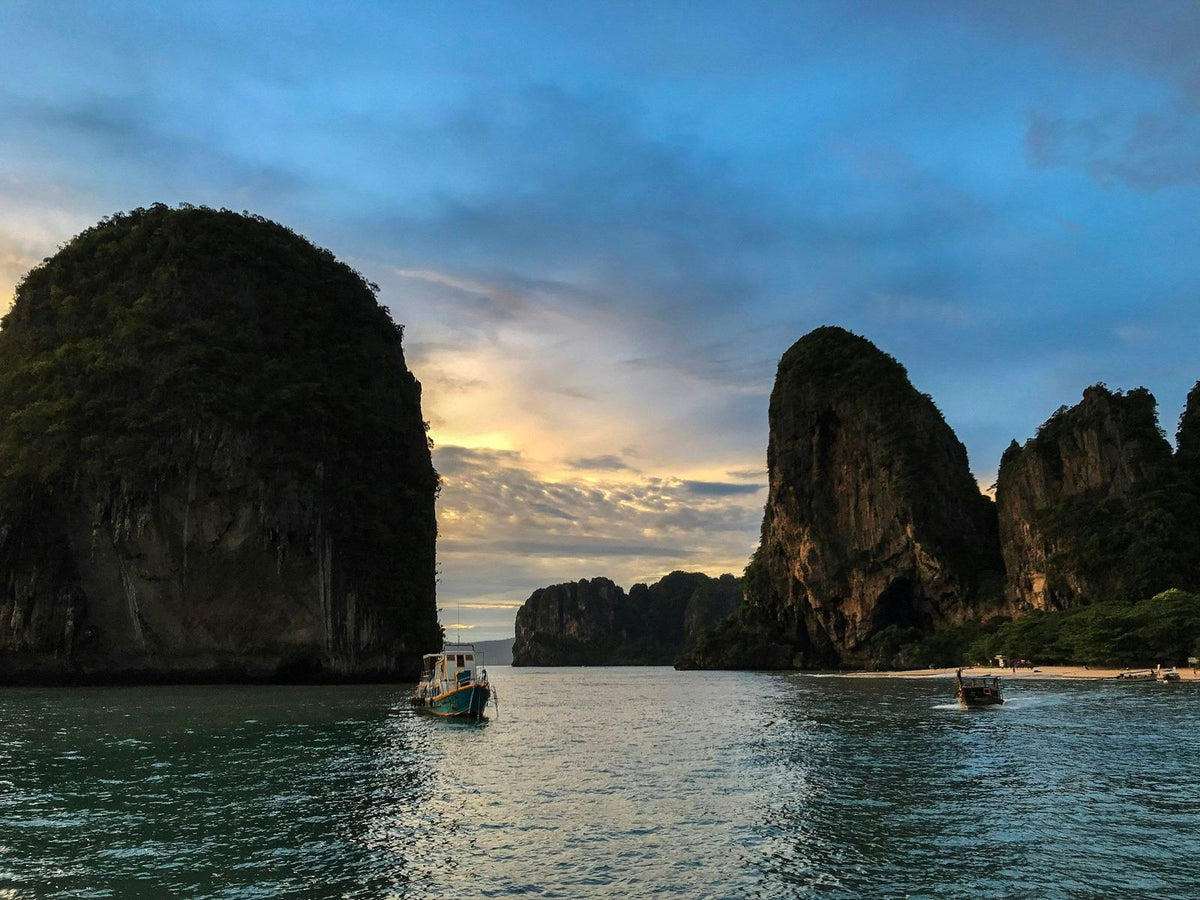 A boat beneath Railay's limestone towers