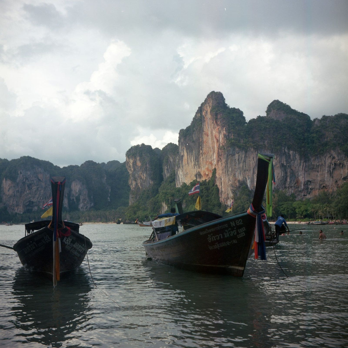 Longtail boats off Railay under a cloudy sky