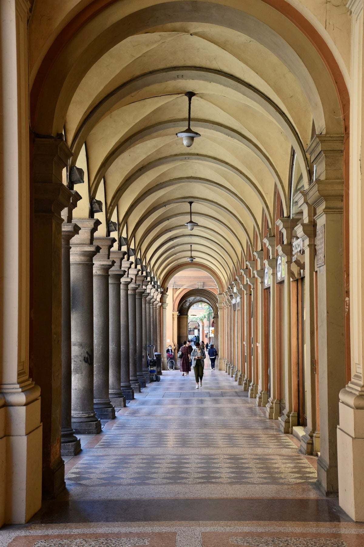 The long colonnade of Via Farini, partly decorated with frescoes