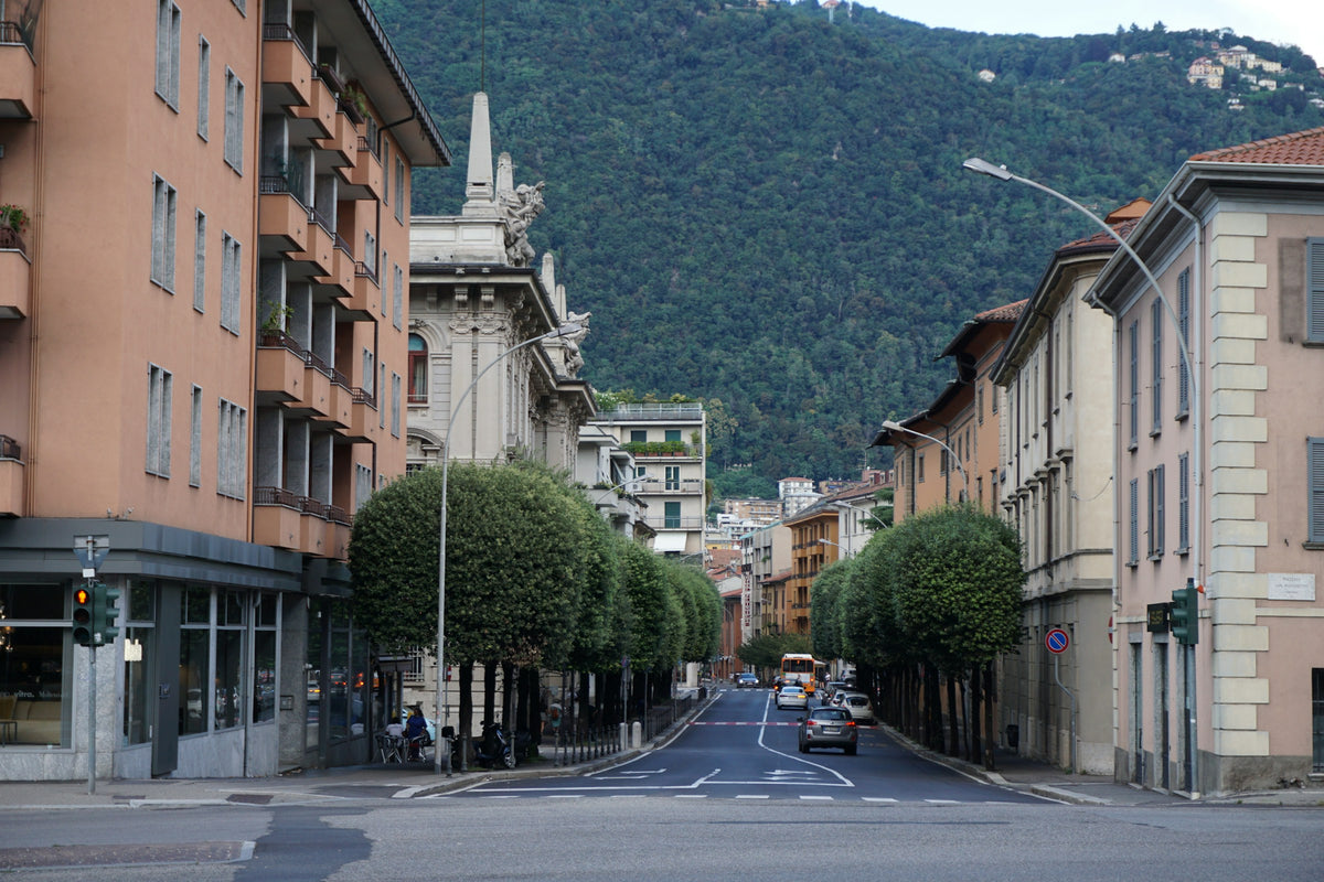 A wide avenue with the hills behind
