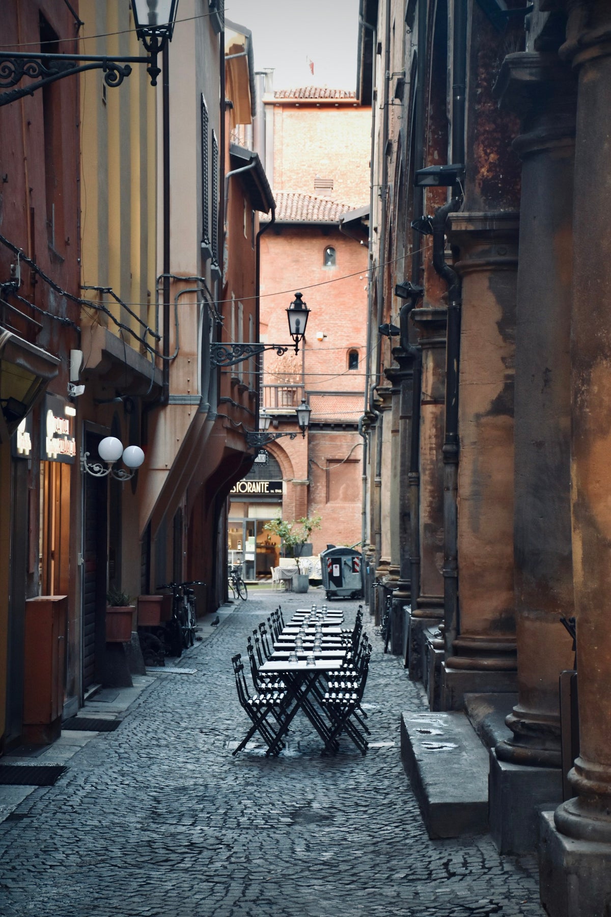 A bar in Bologna with its tables set, waiting for guests