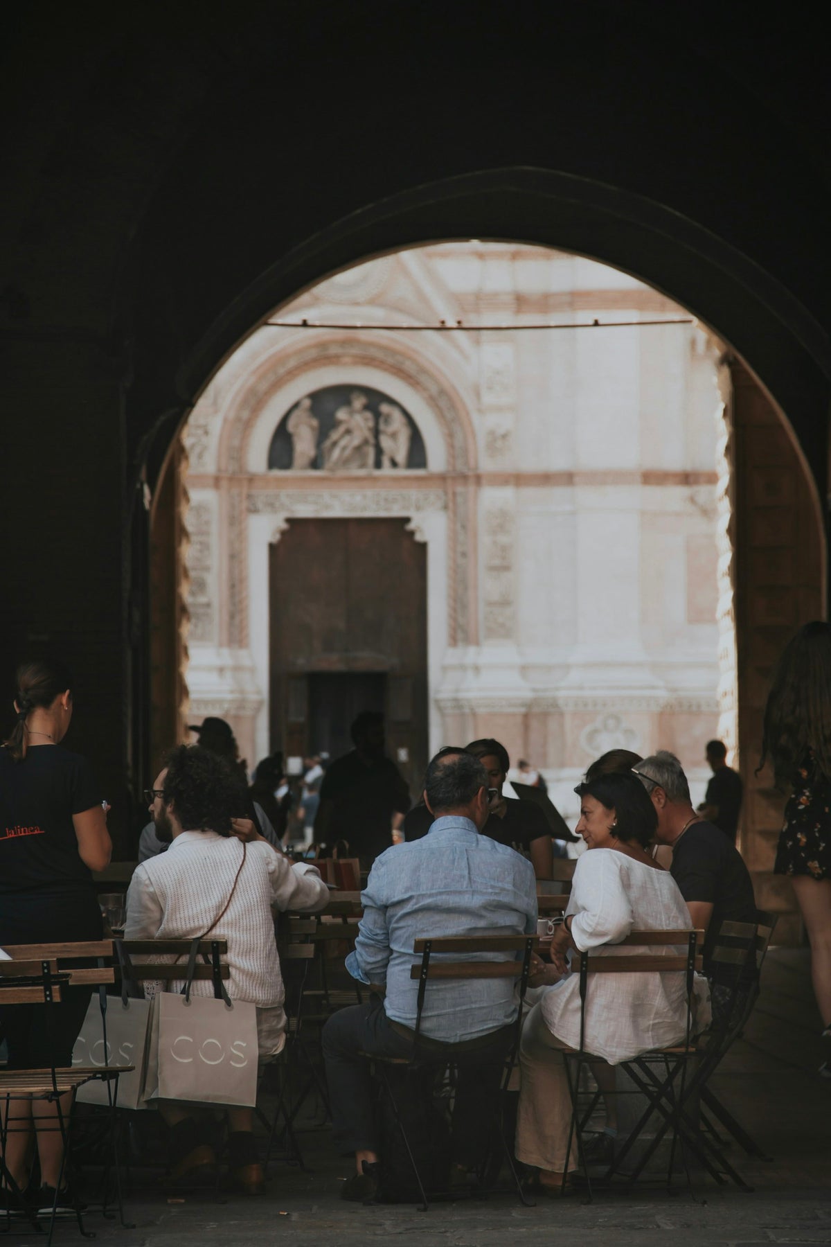 People sitting at outdoor tables in Bologna
