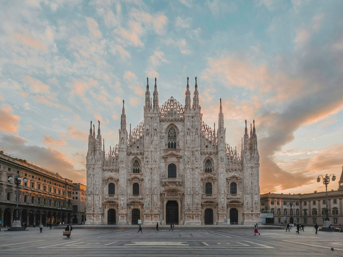 The Duomo di Milano under an orange and blue sky
