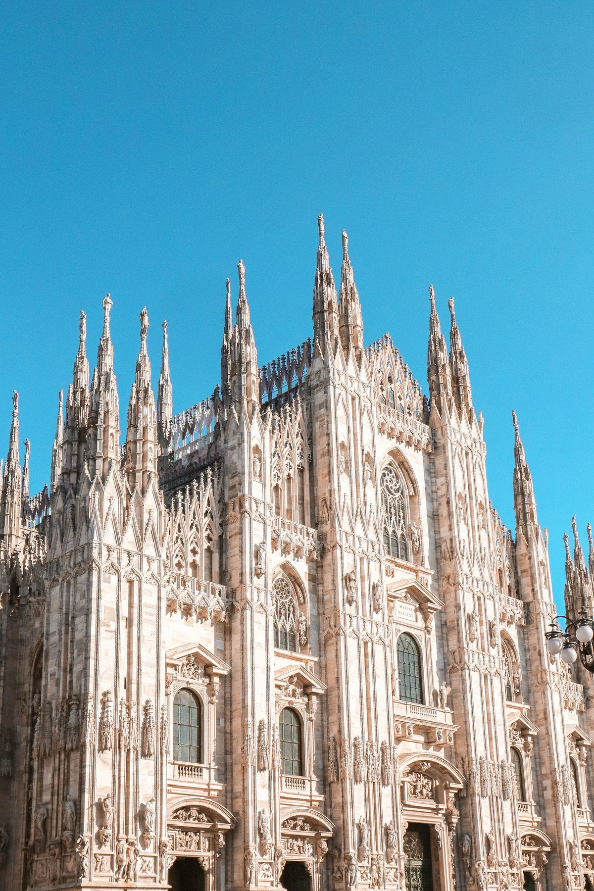 Architectural detail of the Duomo against a blue sky