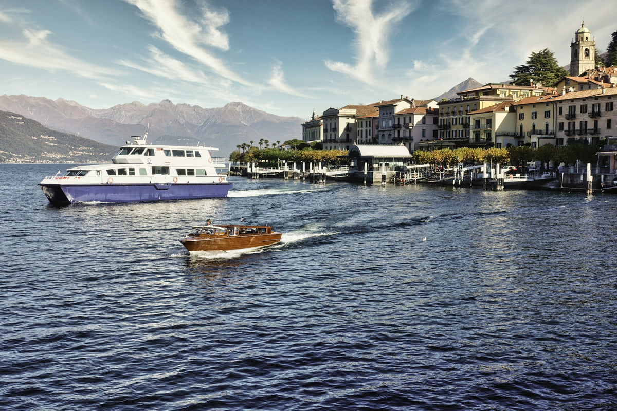 A boat passing along the Bellagio waterfront