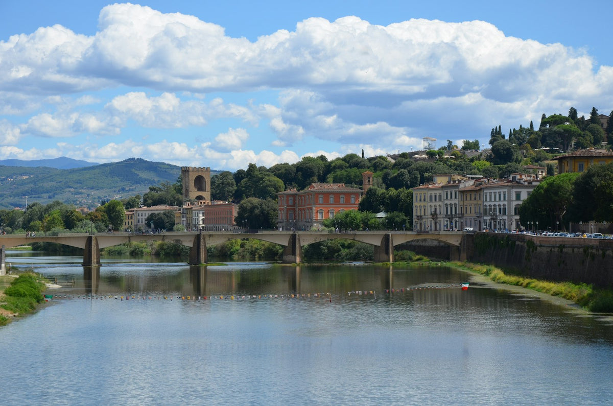 The Arno upstream of the centre, with a bridge and the green hills beyond