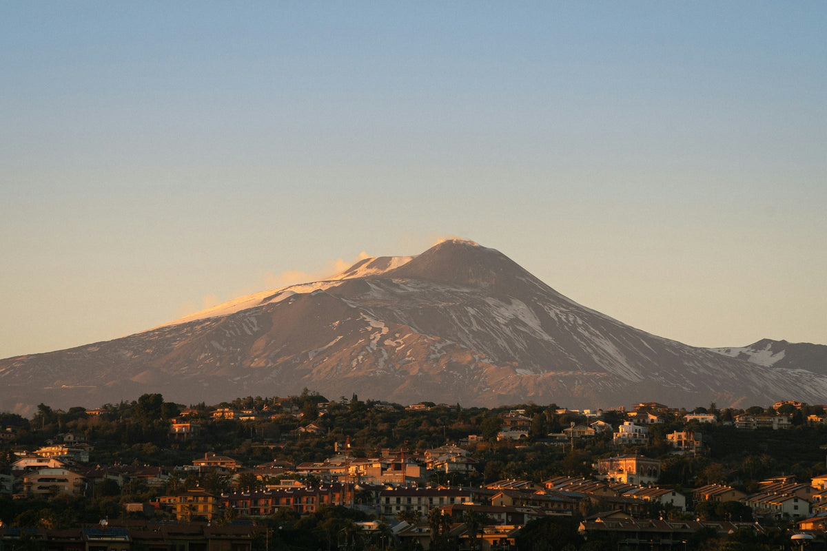 Last light on Mount Etna above the city's edge