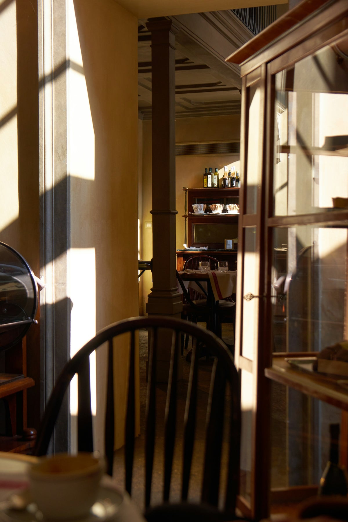 Sunlight streaming into an empty Milan café