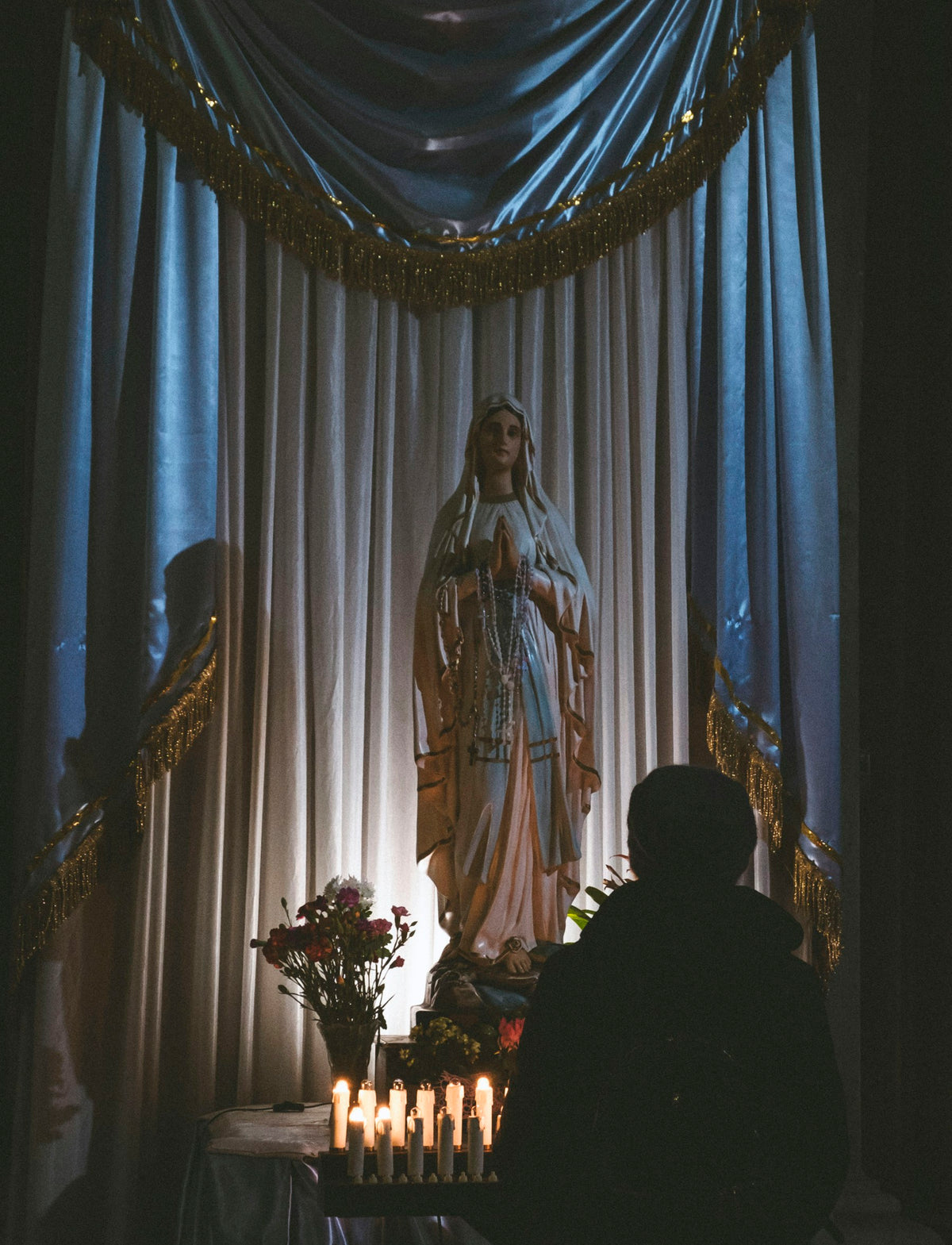 Candles before a statue of the Madonna in Naples Cathedral