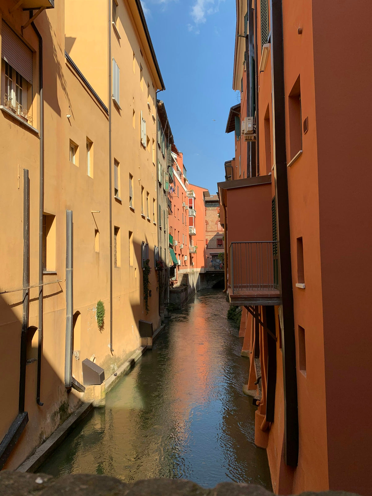 A narrow canal running between buildings in Bologna