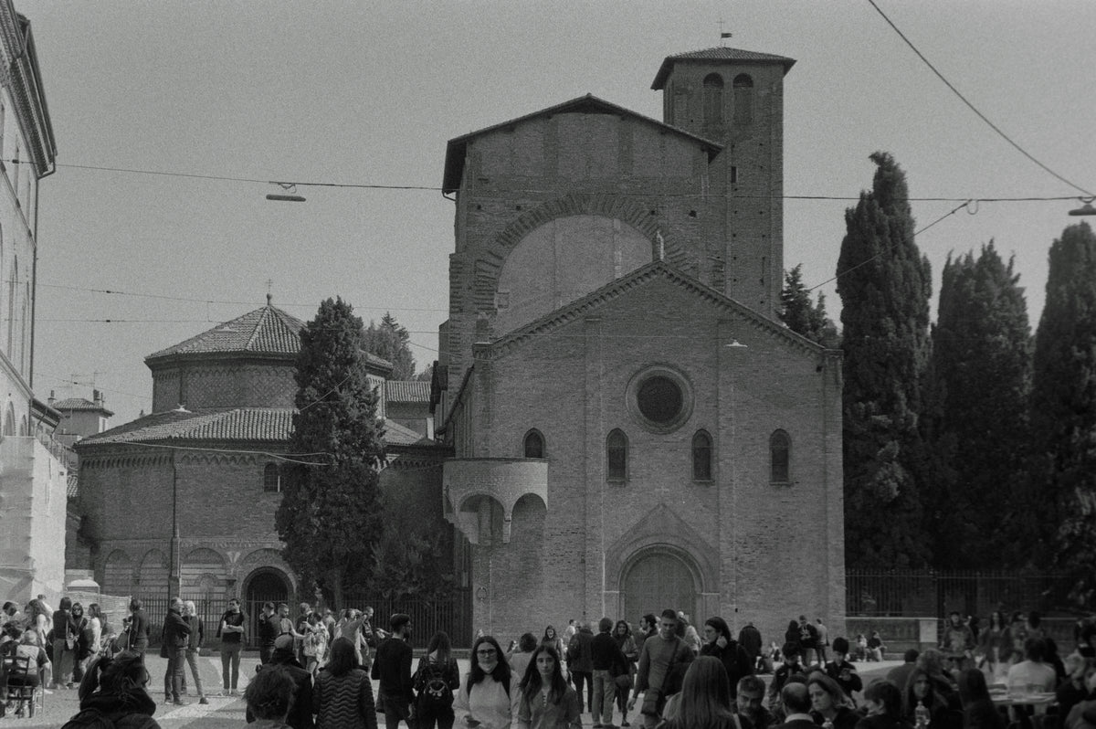 A large crowd gathered in front of a church in Bologna