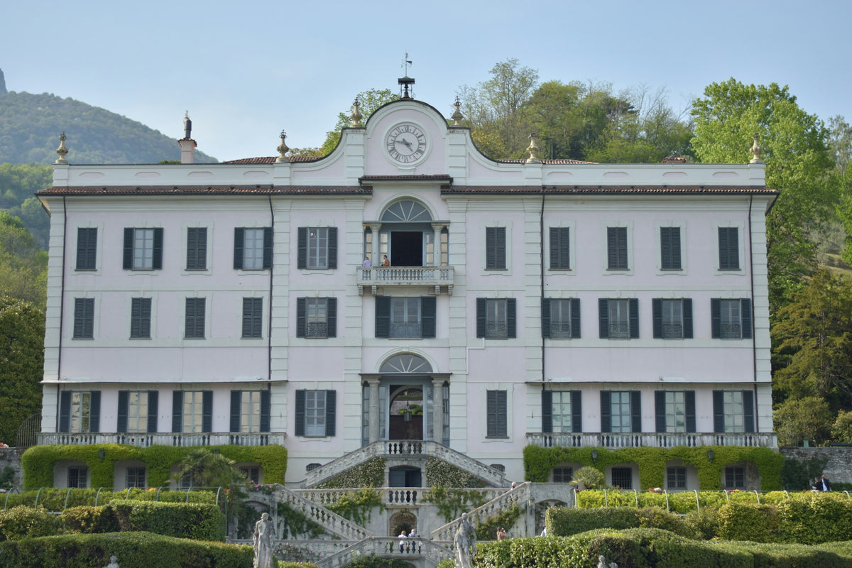 A white lakeside building with a fountain in Tremezzo