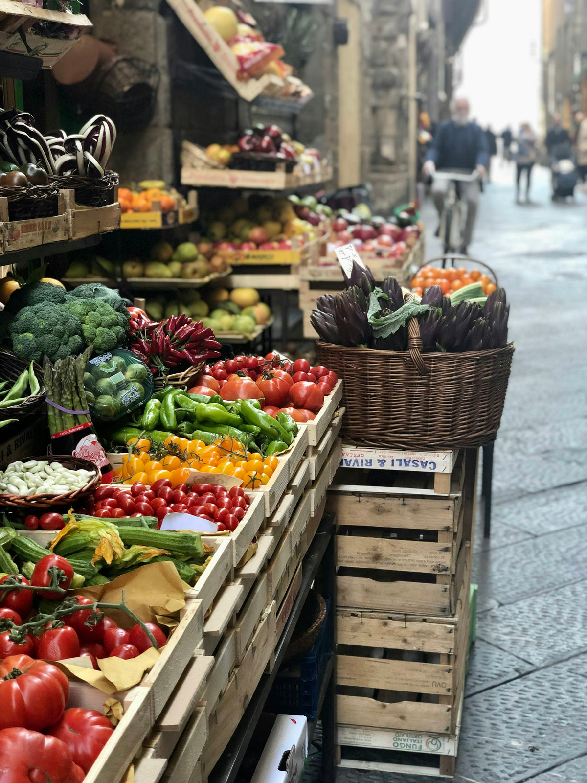 A greengrocer's display of fresh vegetables on a Florence street
