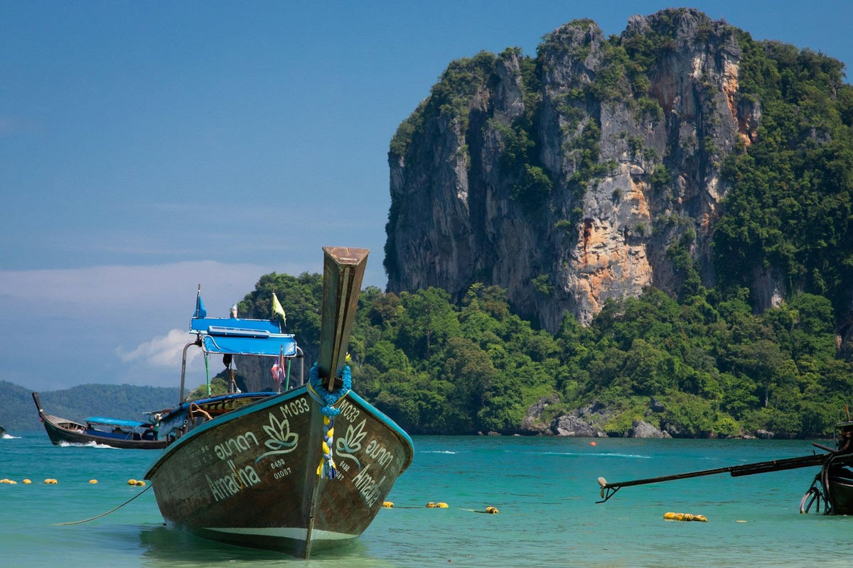 A longtail boat close up with Railay Beach behind