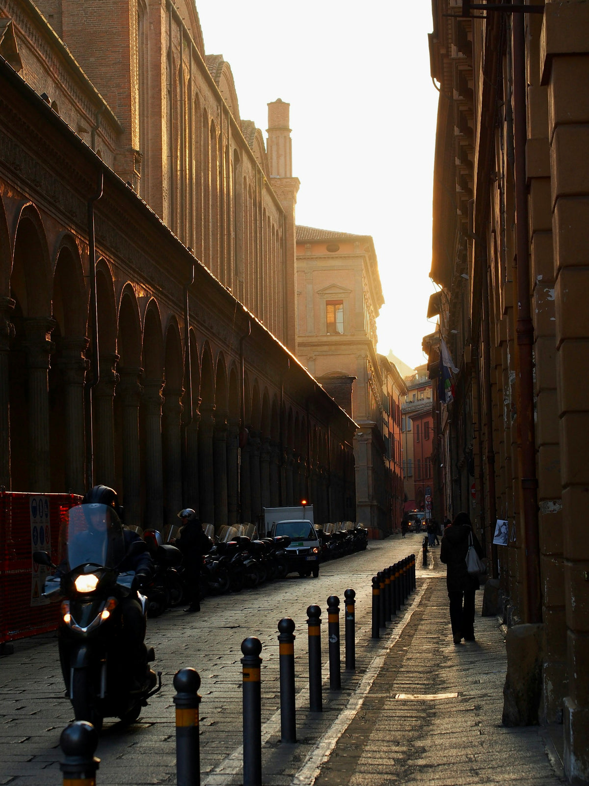 A busy Bologna street with scooters and motorcycles