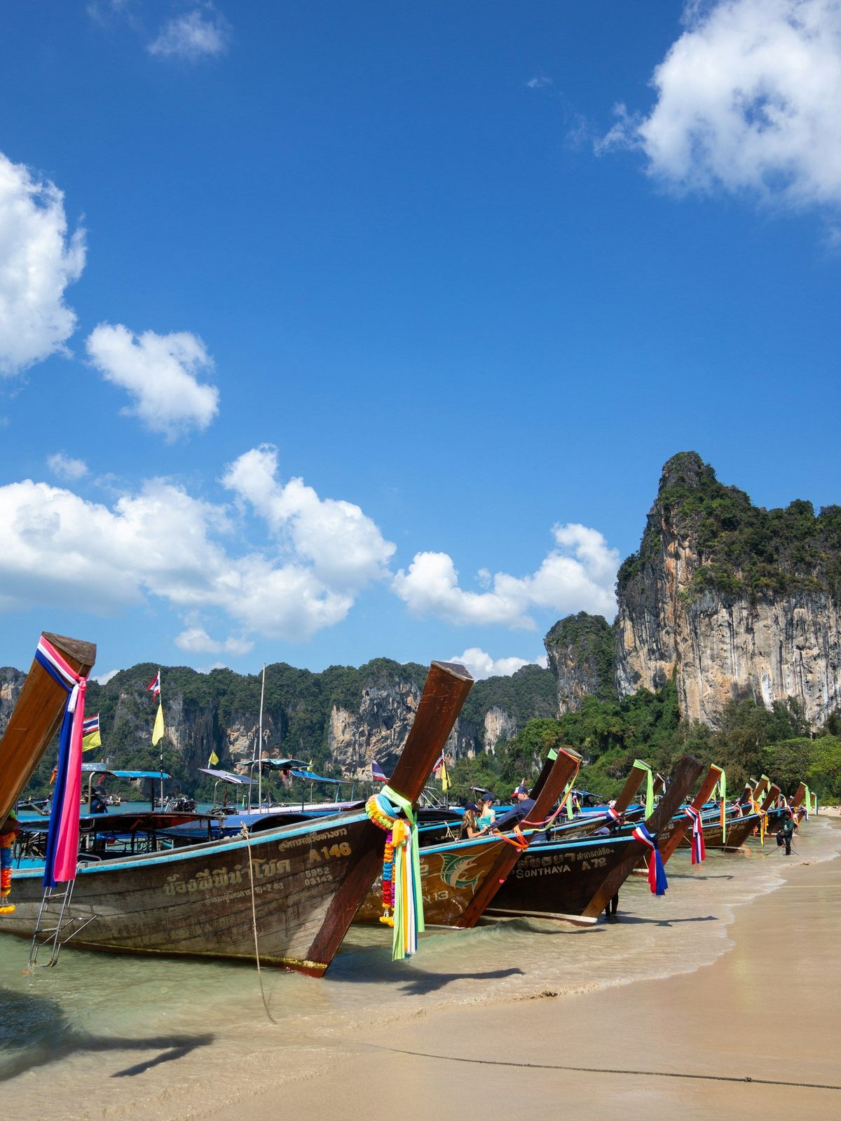 Longtail boats lined up on the sand at Railay
