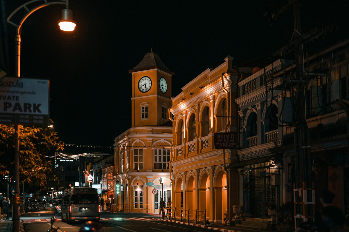 Phuket Old Town street at night with the clock tower