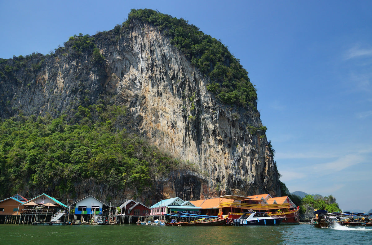 Stilt houses of Koh Panyee at the foot of a limestone cliff