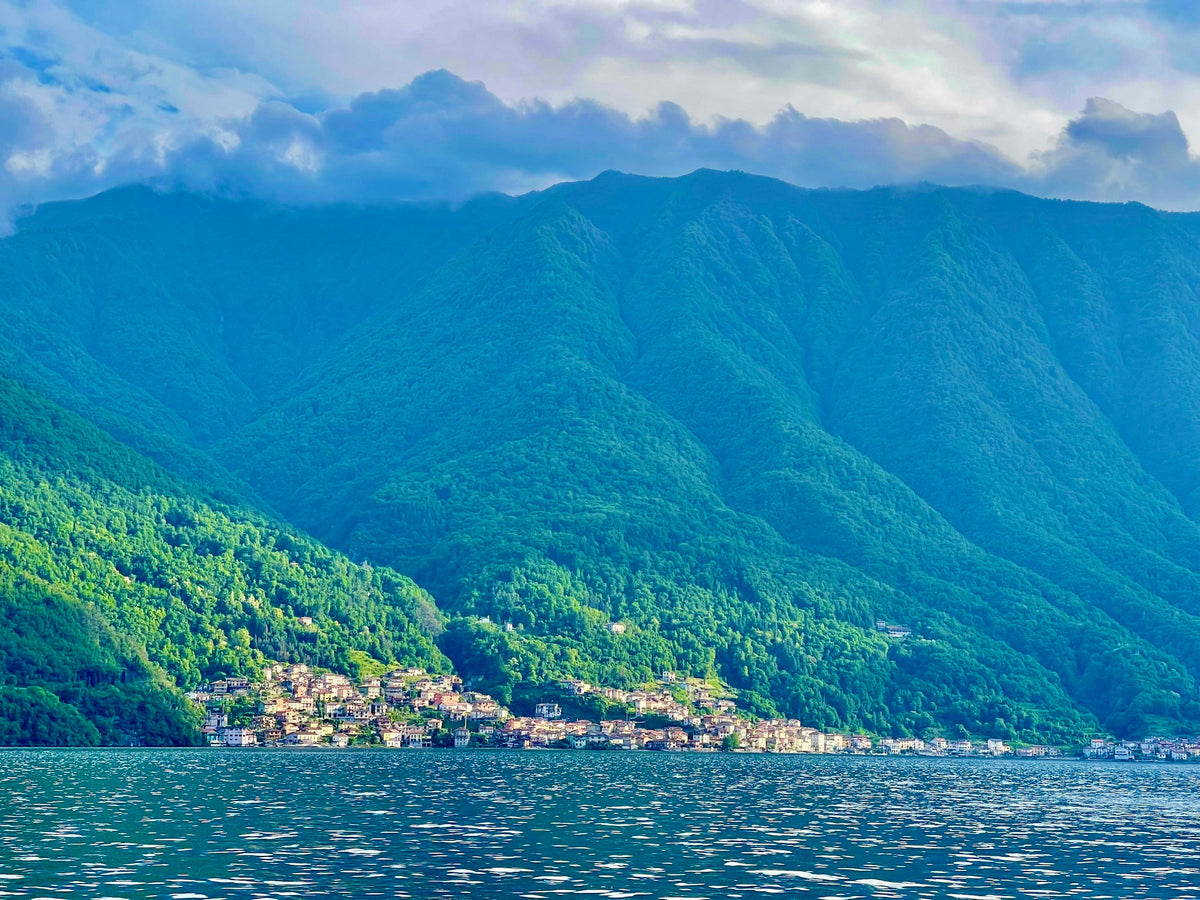 A boat on the lake off Tremezzo with mountains behind