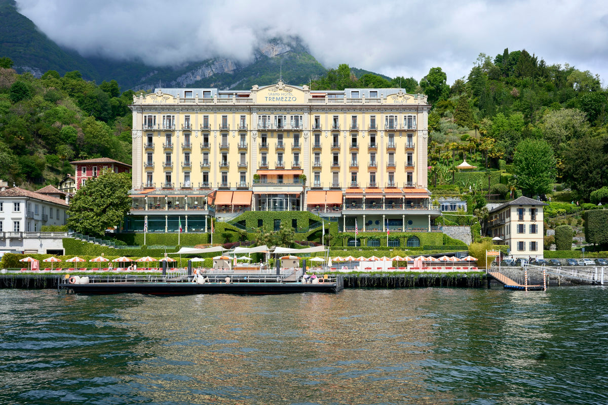 A grand lakeside building against the green hills of Tremezzo