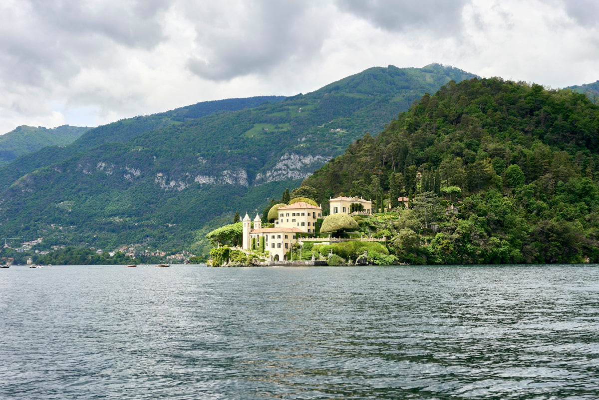 A white villa on the green hillside at Lenno
