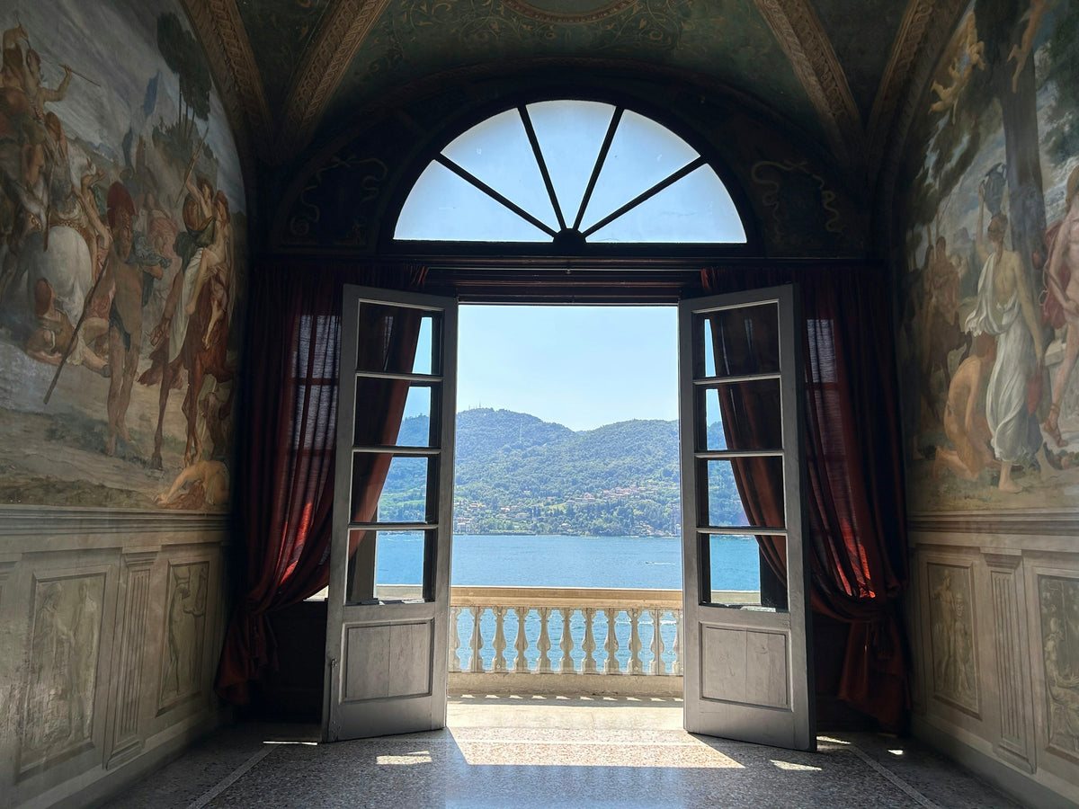 Open door onto a lake-view balcony at Villa Carlotta