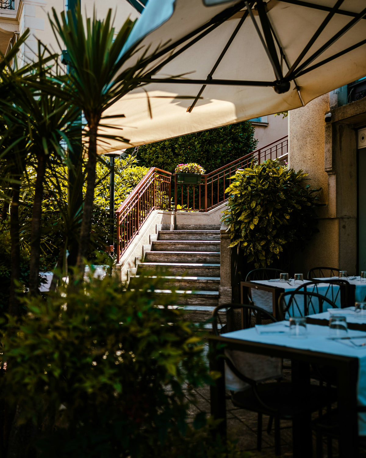 Garden tables at the foot of a stairway