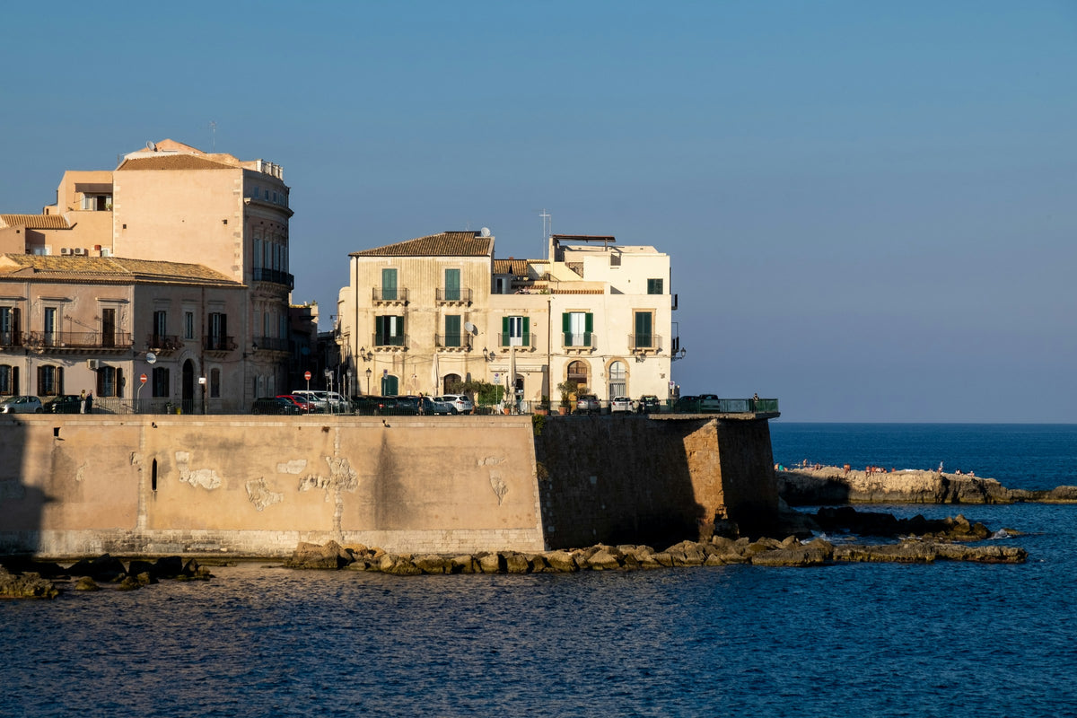 Golden light on the sea walls of Ortigia