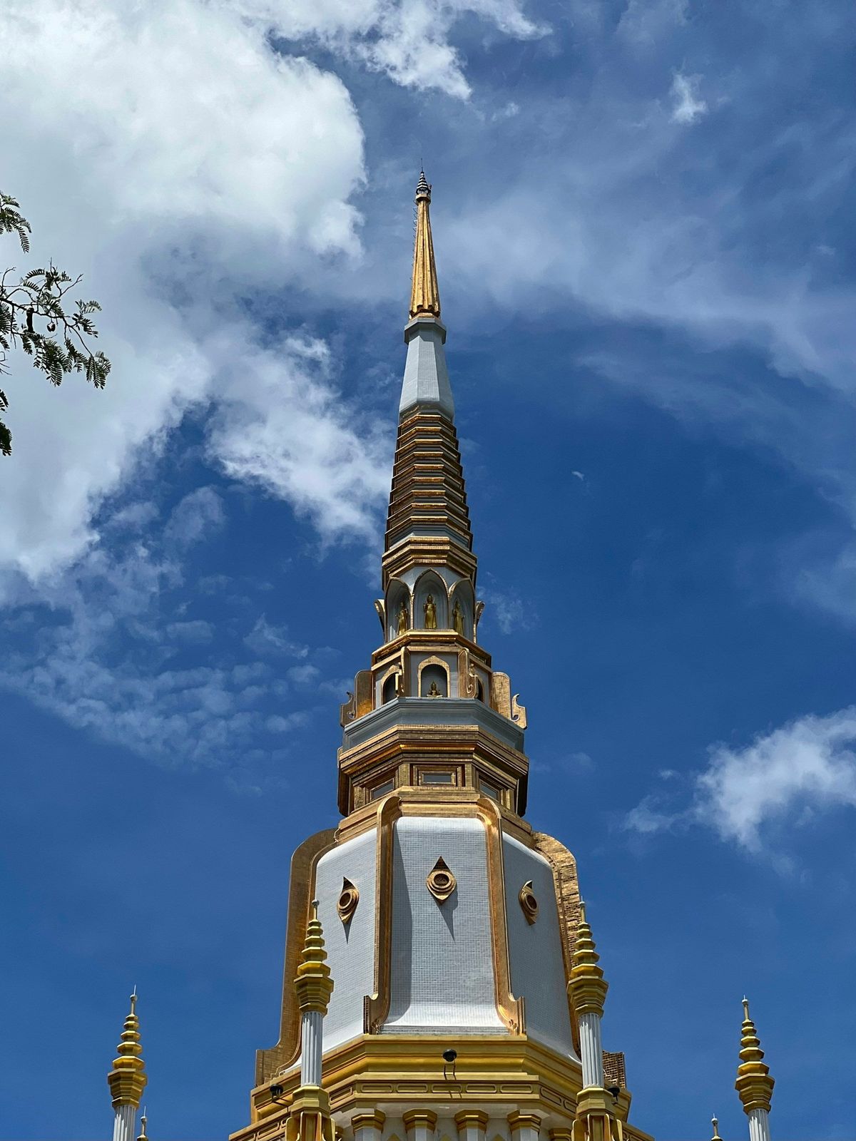 A gilded pagoda spire against a blue sky in Krabi