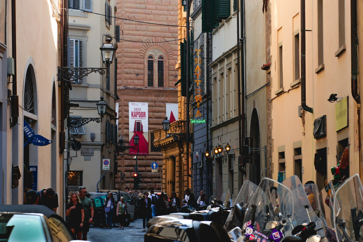Scooters and passers-by in a busy street of the centre