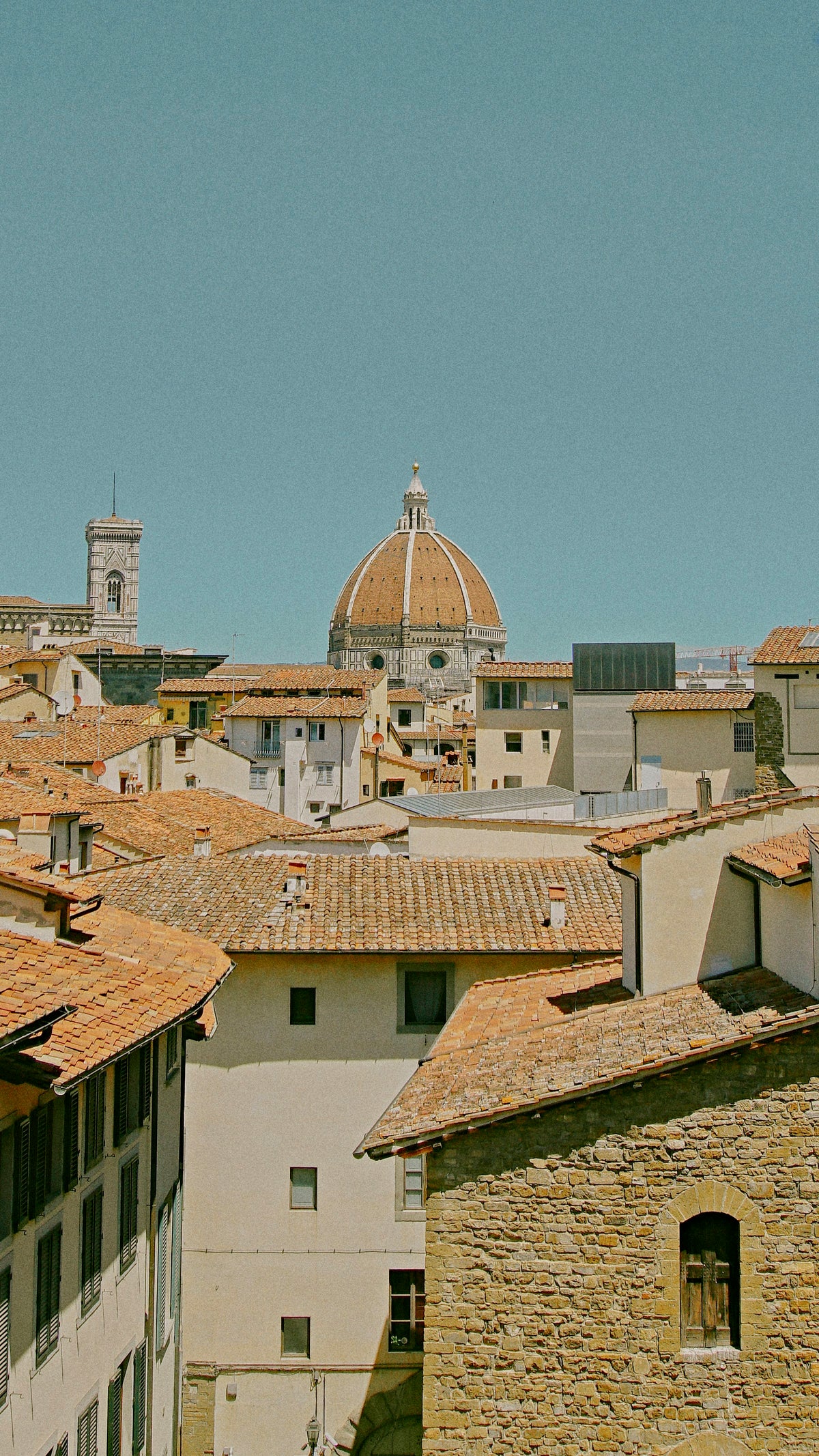 Brunelleschi's dome and Giotto's bell tower above terracotta roofs