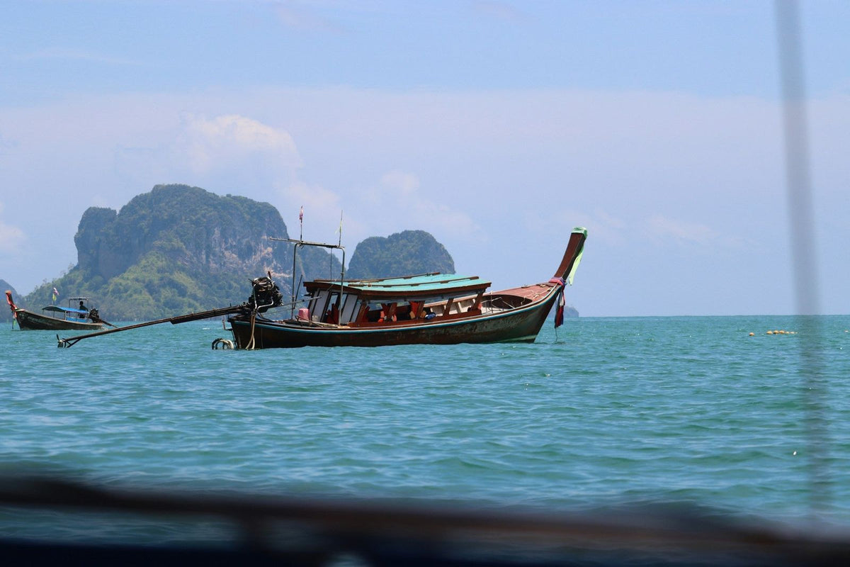 A longtail boat and limestone islands off the Krabi coast