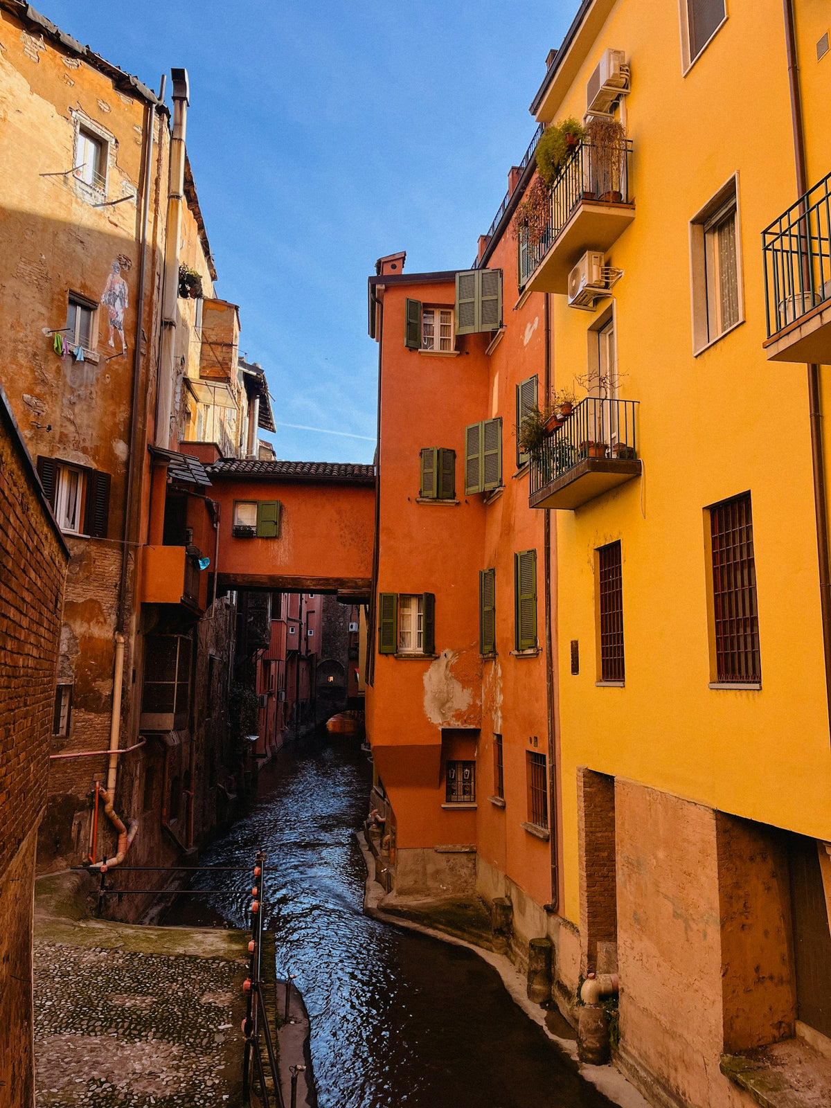 A canal running between houses in Bologna
