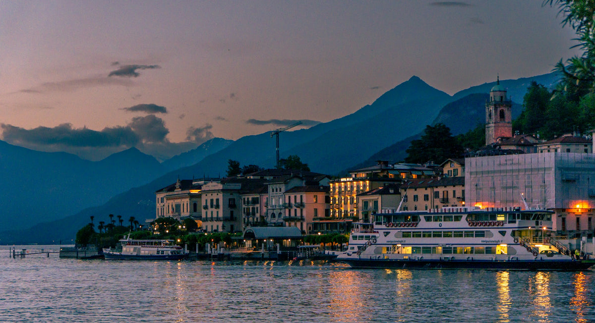 A ferry docked at Bellagio's waterfront at blue hour