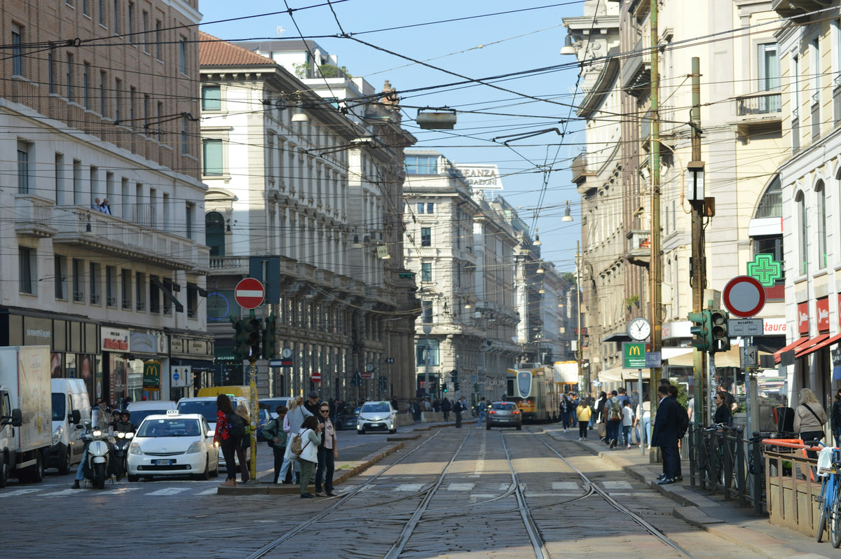 Traffic and a tram on a busy Milan street