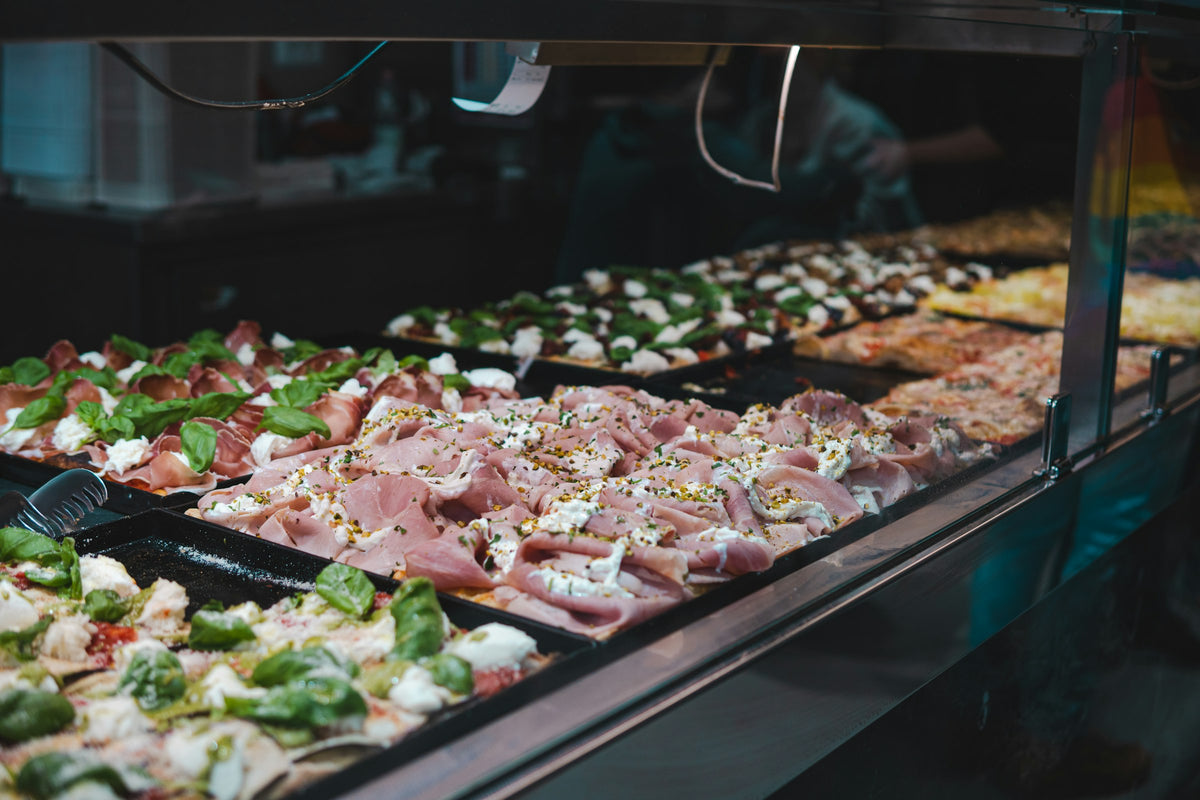 Trays of pizza al taglio in a Rome shop window