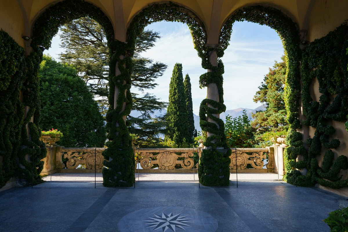 A courtyard of Villa del Balbianello seen through an archway