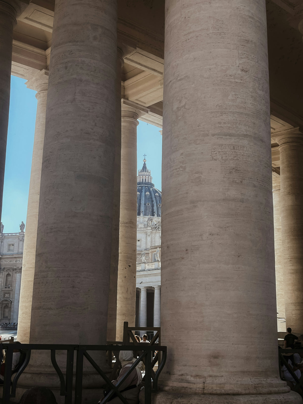 St Peter's dome glimpsed between the columns of Bernini's colonnade