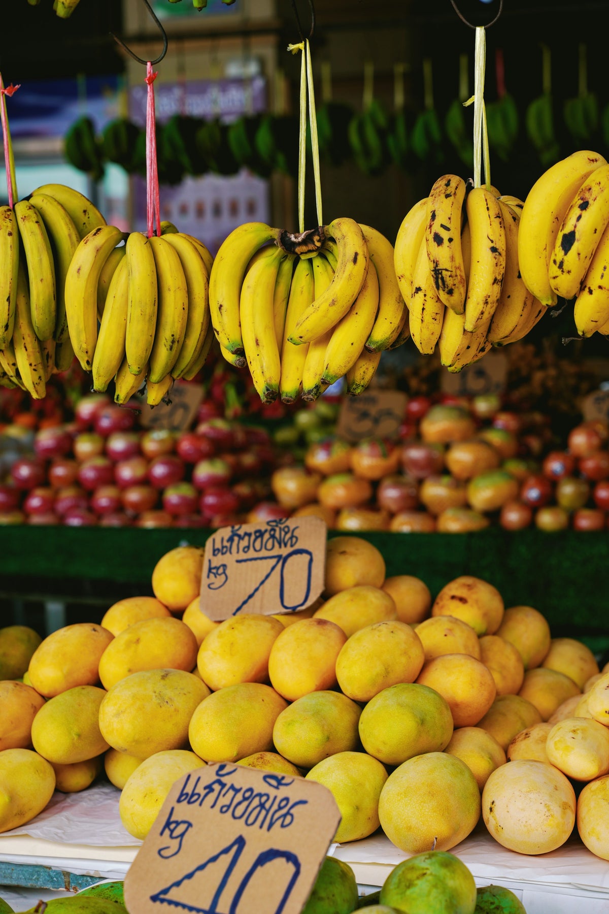 Bananas and mangoes at a market fruit stall in Thailand