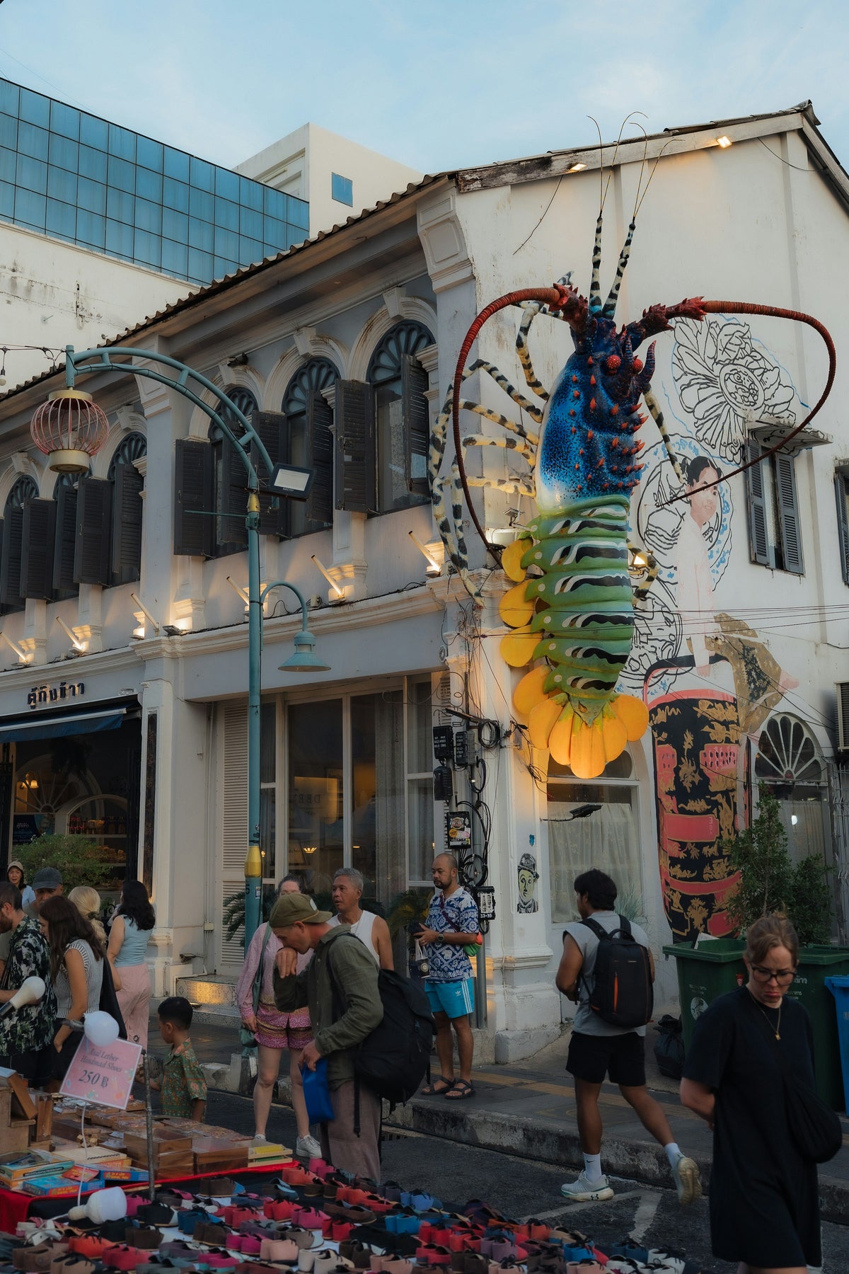 Lobster art installation above market stalls in Phuket Old Town