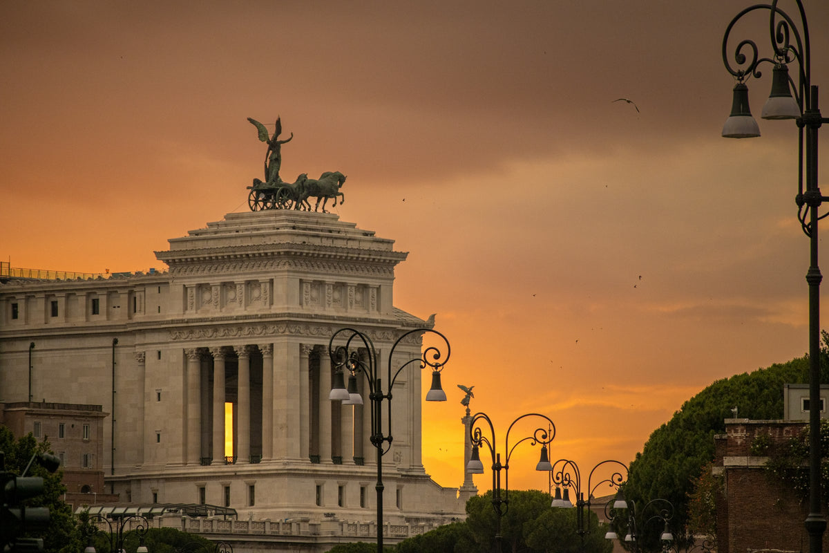 The Vittoriano's bronze quadriga against a sunset sky