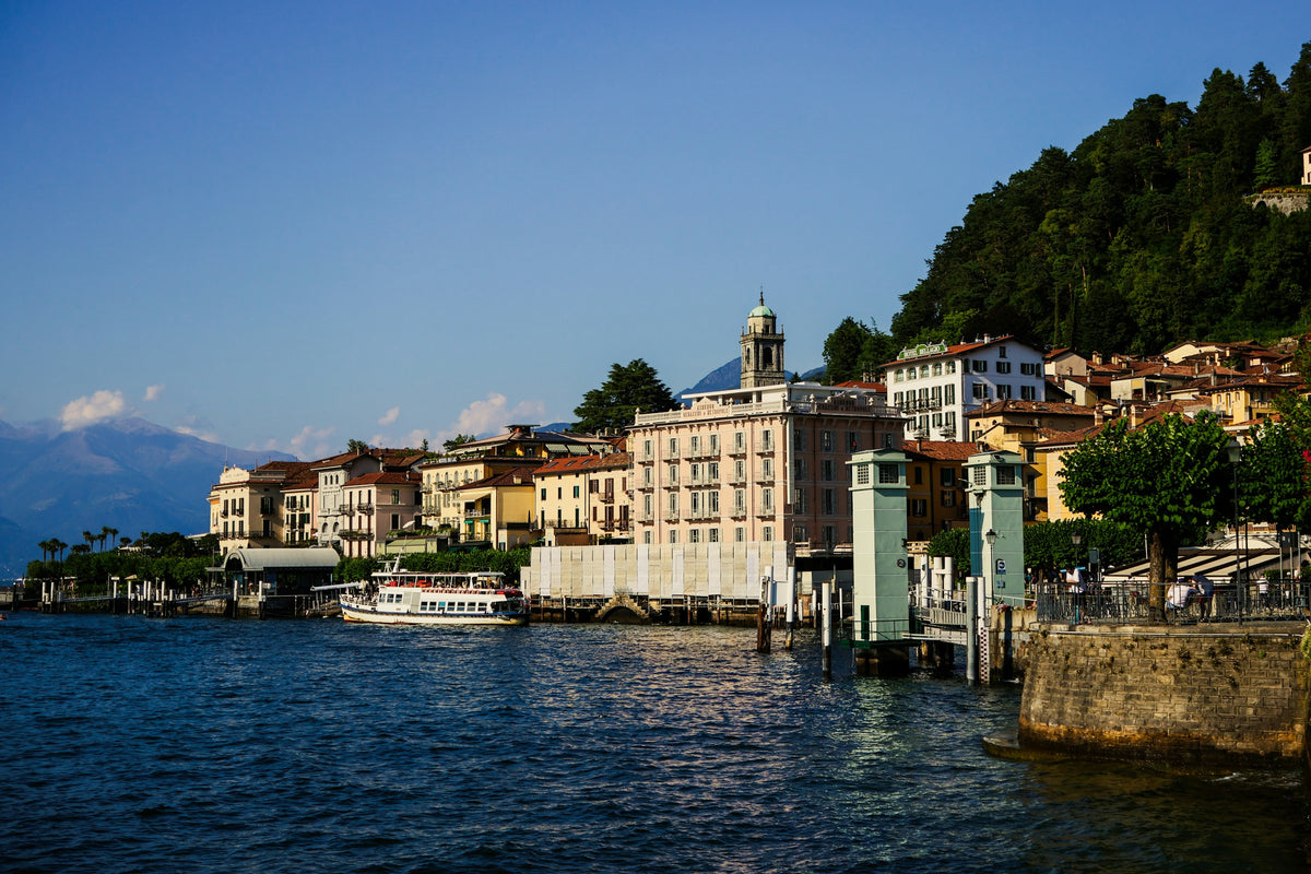 Bellagio's lakefront buildings with a boat approaching
