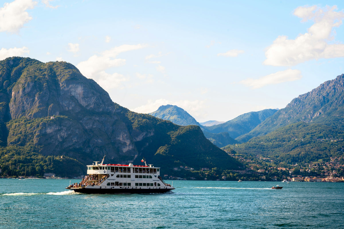 A ferry on the lake at Bellagio with mountains behind