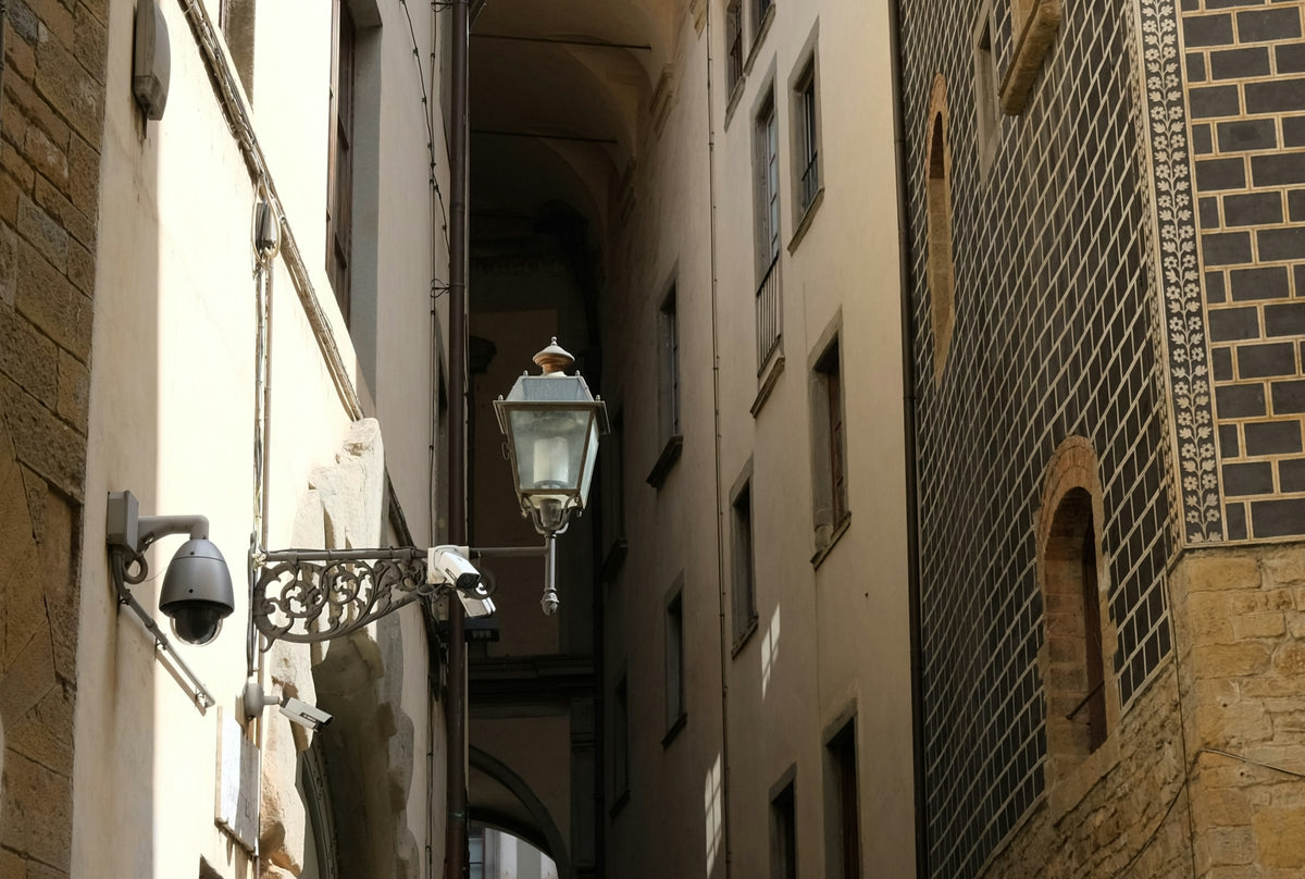 A wrought-iron street lamp in a narrow lane of the centre