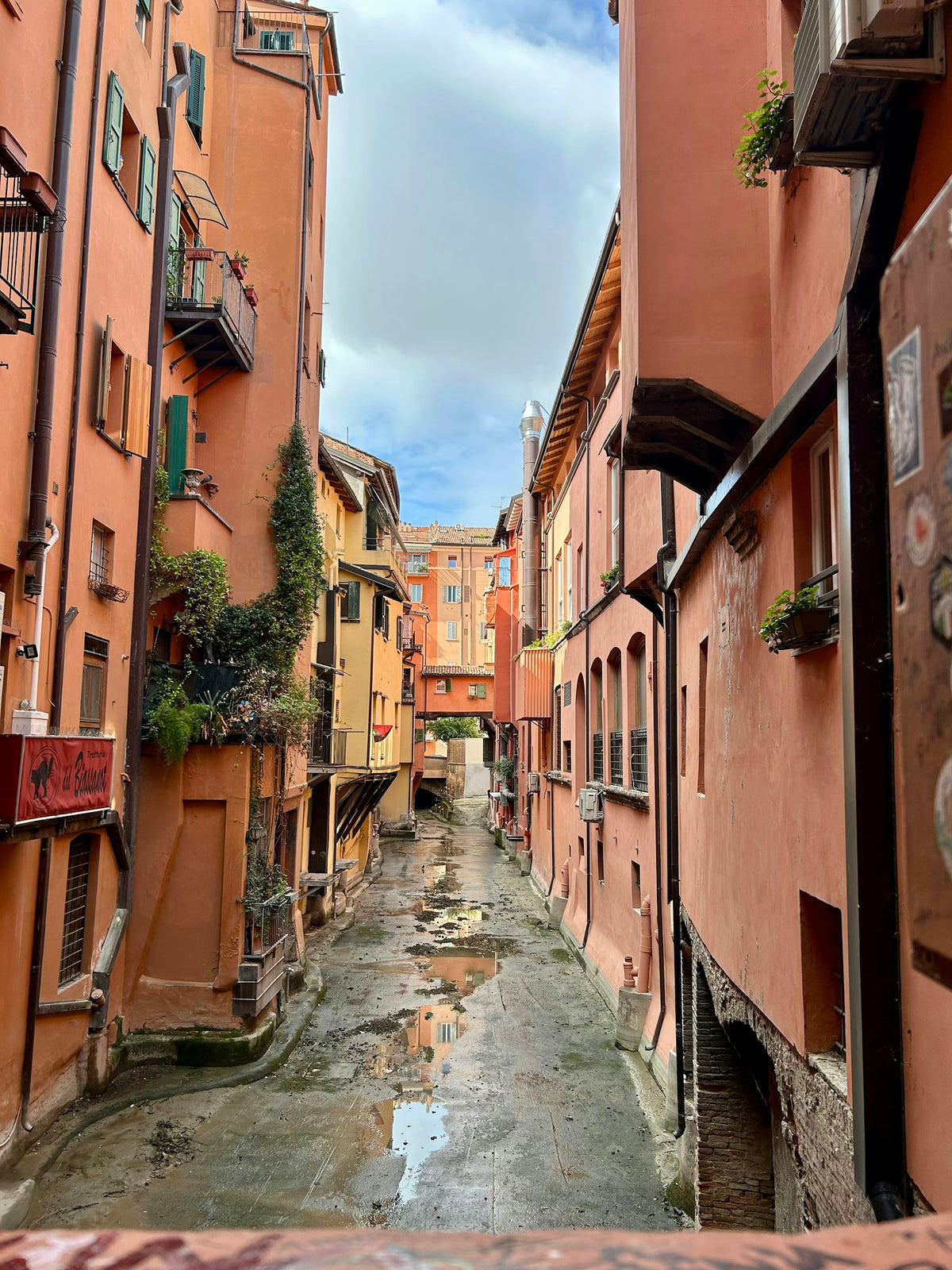Orange houses and wet cobblestones by the Canale delle Moline