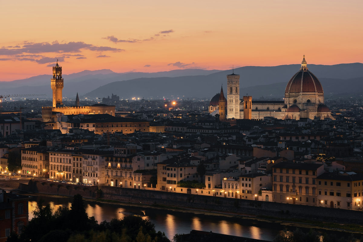 Florence at dusk, with the Duomo and Palazzo Vecchio above the Arno