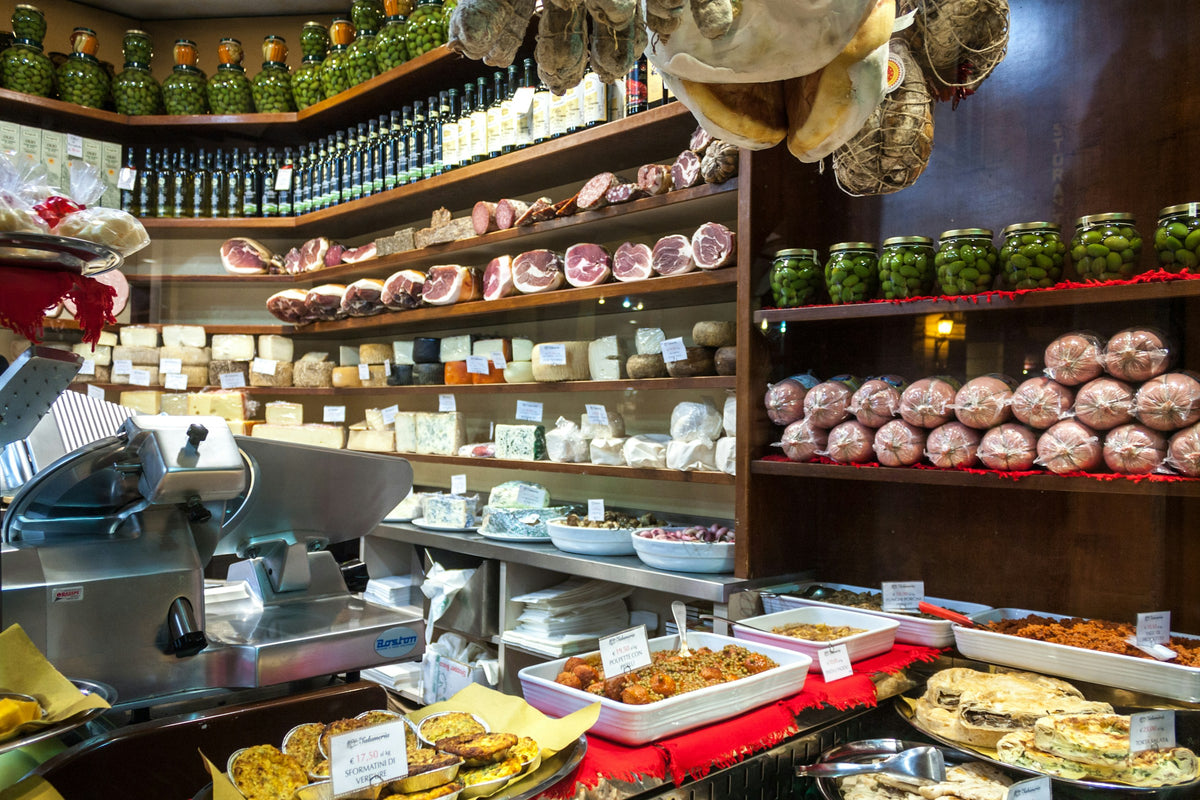 A Bologna delicatessen counter with cheeses, cured meats, olives and prepared dishes