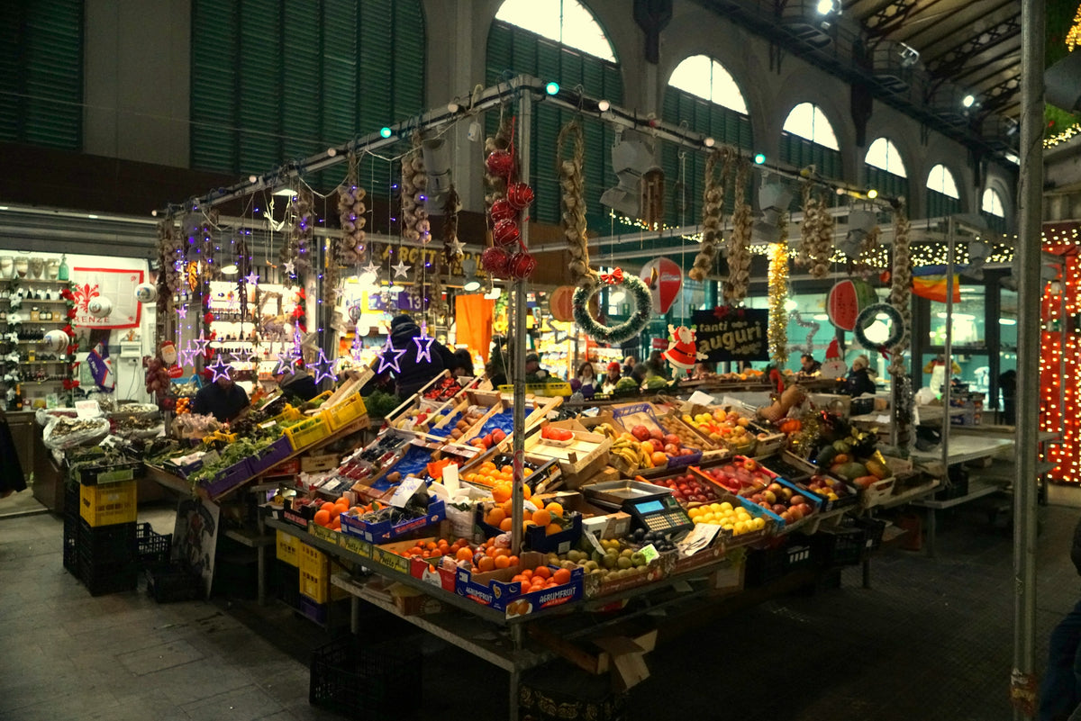A Milan market stall piled with fresh fruit and vegetables