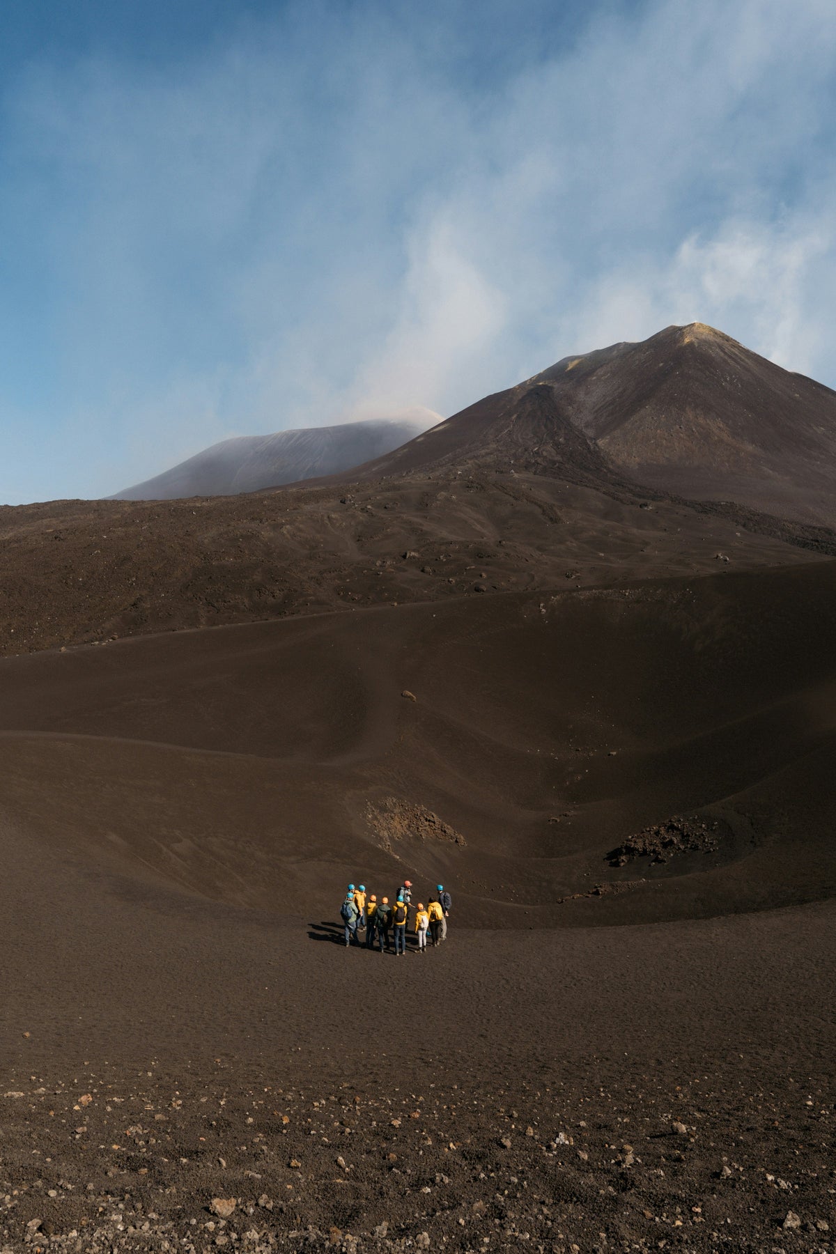 Hikers dwarfed by Etna's volcanic slopes