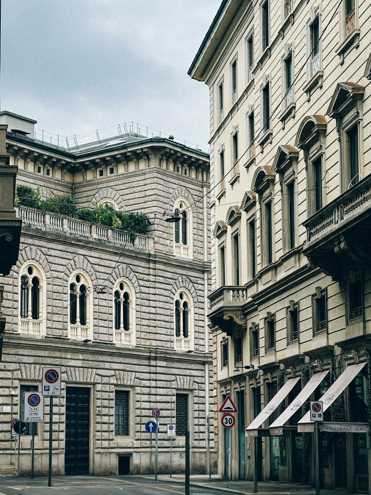 Ornate buildings along a quiet Milan street